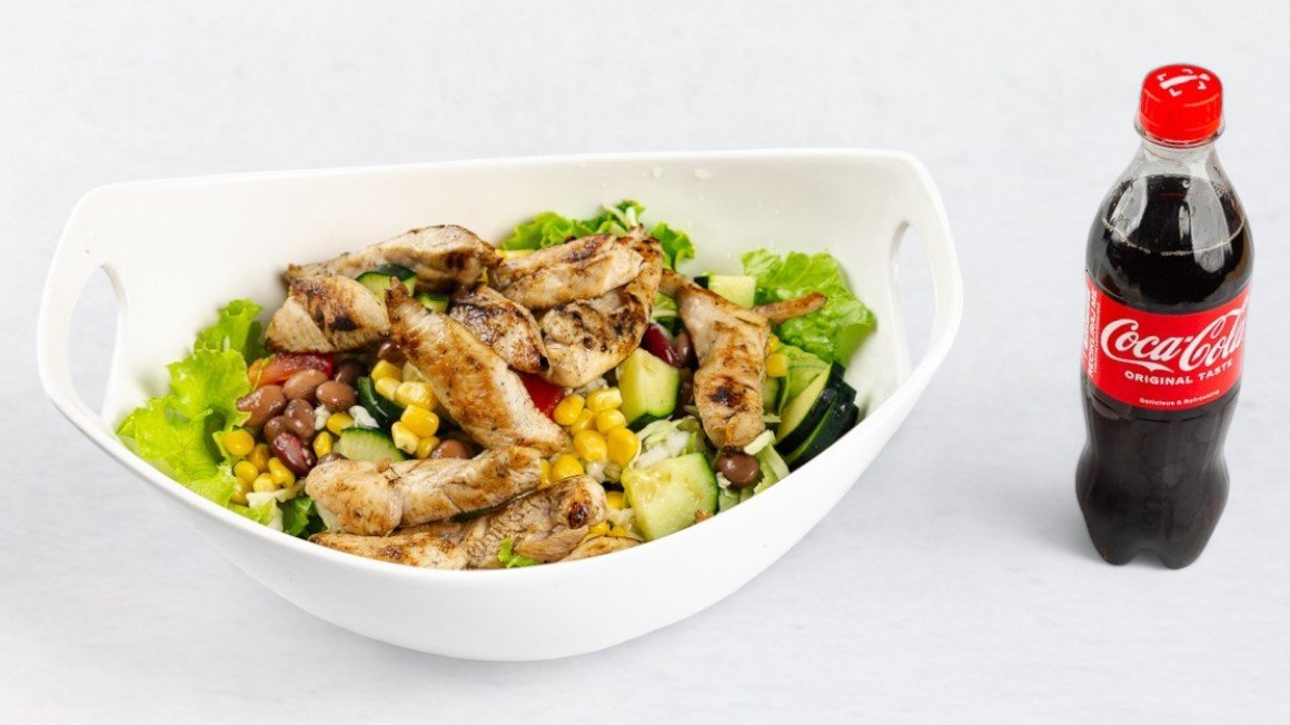 Salad plate with roasted chicken meat and Coca-Cola 0.5 l