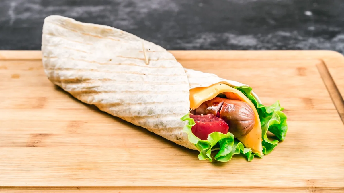Cheese topped wrapped hot dog