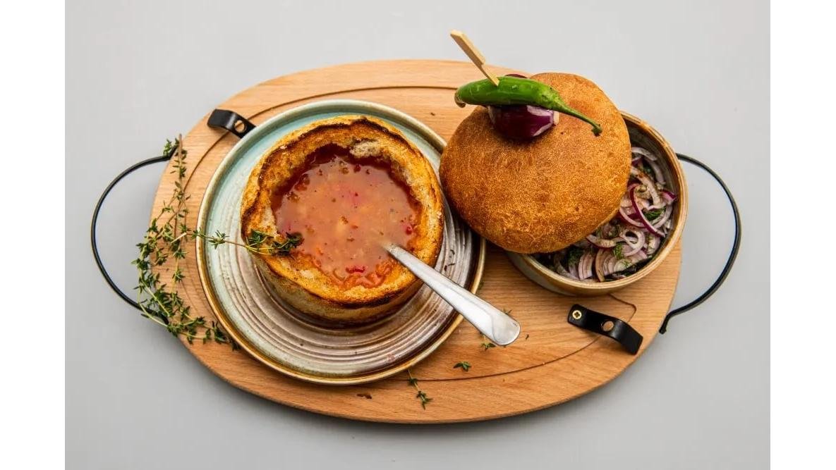 Ciorbă de fasole cu costiță în pâine și salată de ceapă roșie
