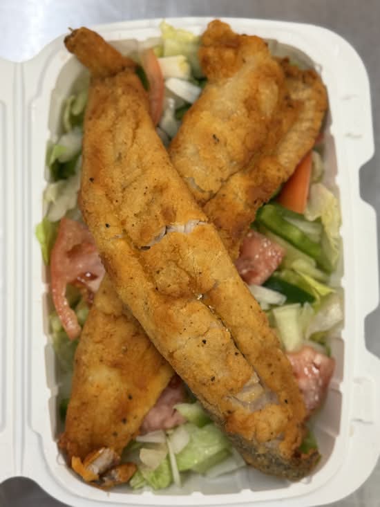 Whiting fish over salad