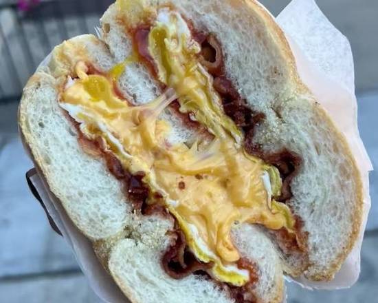 Bacon, egg, cheese, salt, pepper, ketchup on a KAISER ROLL