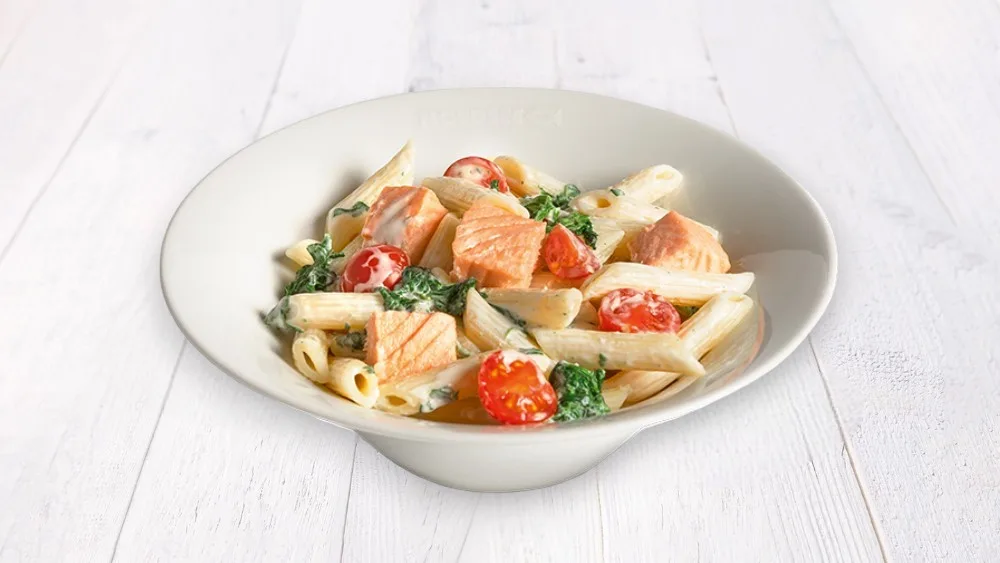 Salmon pasta with spinach leaves