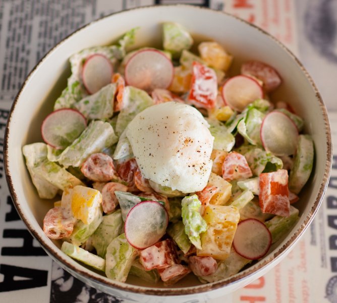 Village salad with egg and sour cream