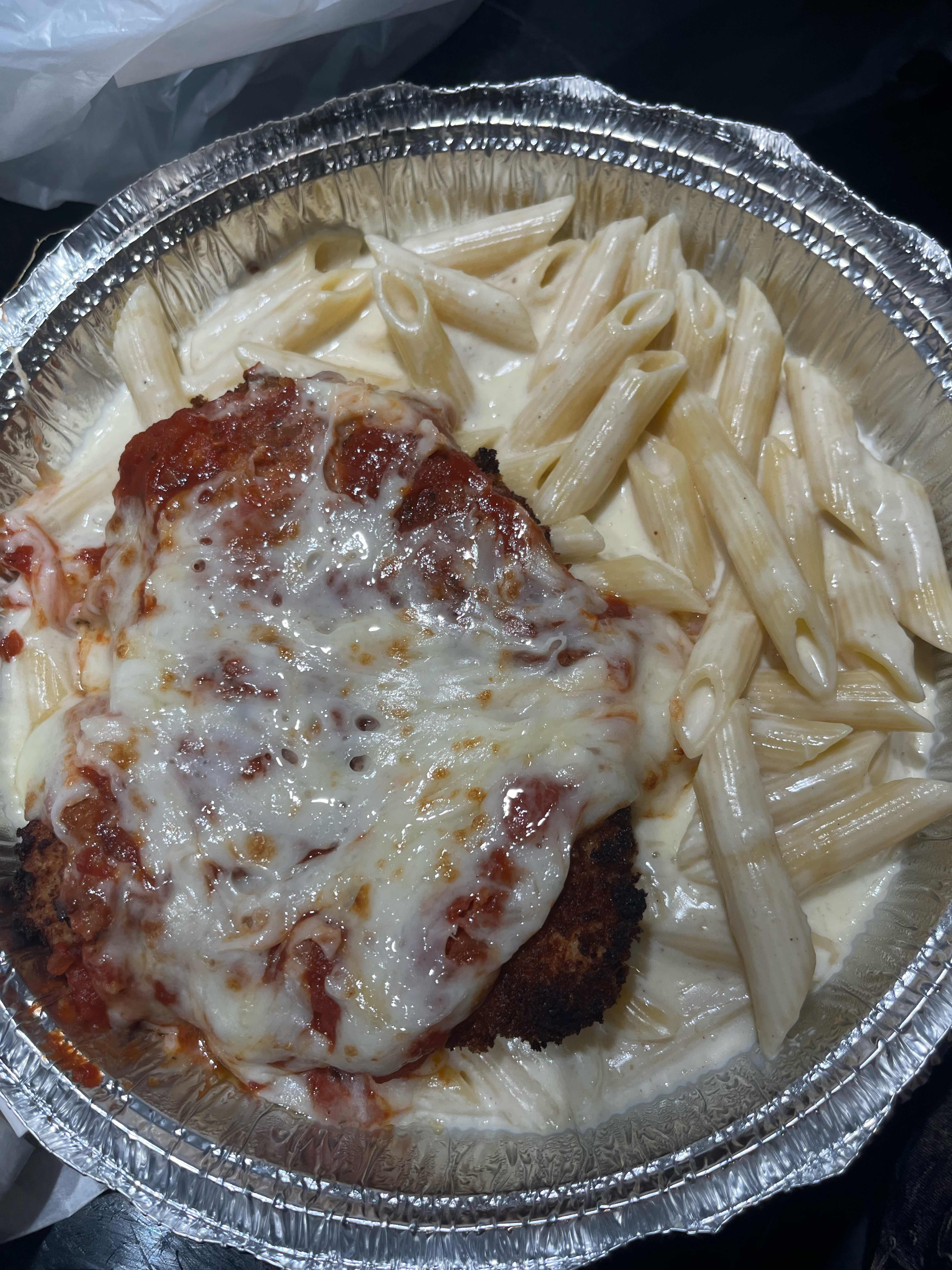 Chicken Parmesan with penne alfredo and garlic bread