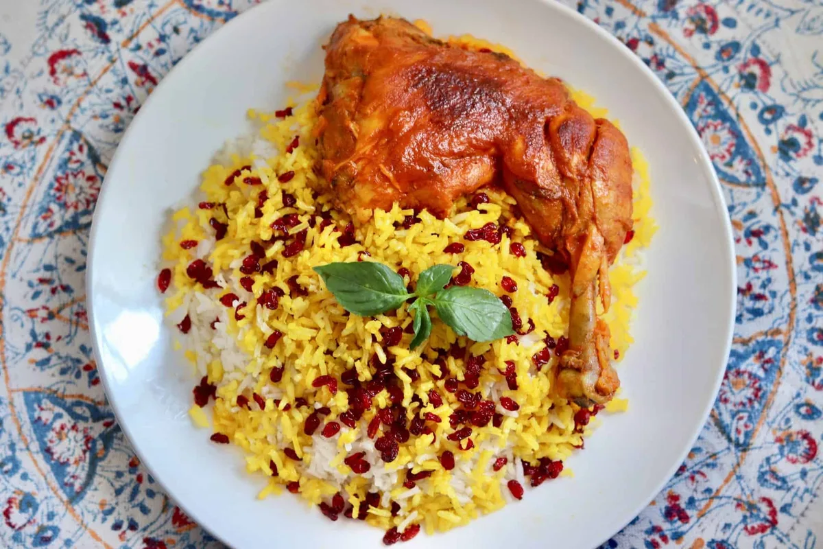 Zereshk Polo ( fried chicken leg + sauce and  rice )