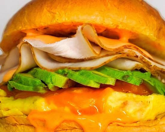 Brioche, Bacon, Turkey, Avocado, Egg, and Cheddar Breakfast Sandwich
