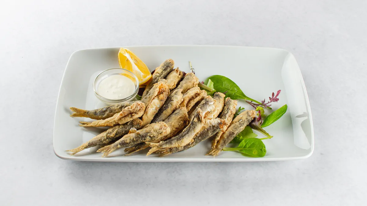 Ocvrte sardele s krompirjevo solato / Fried sardines with potato salad